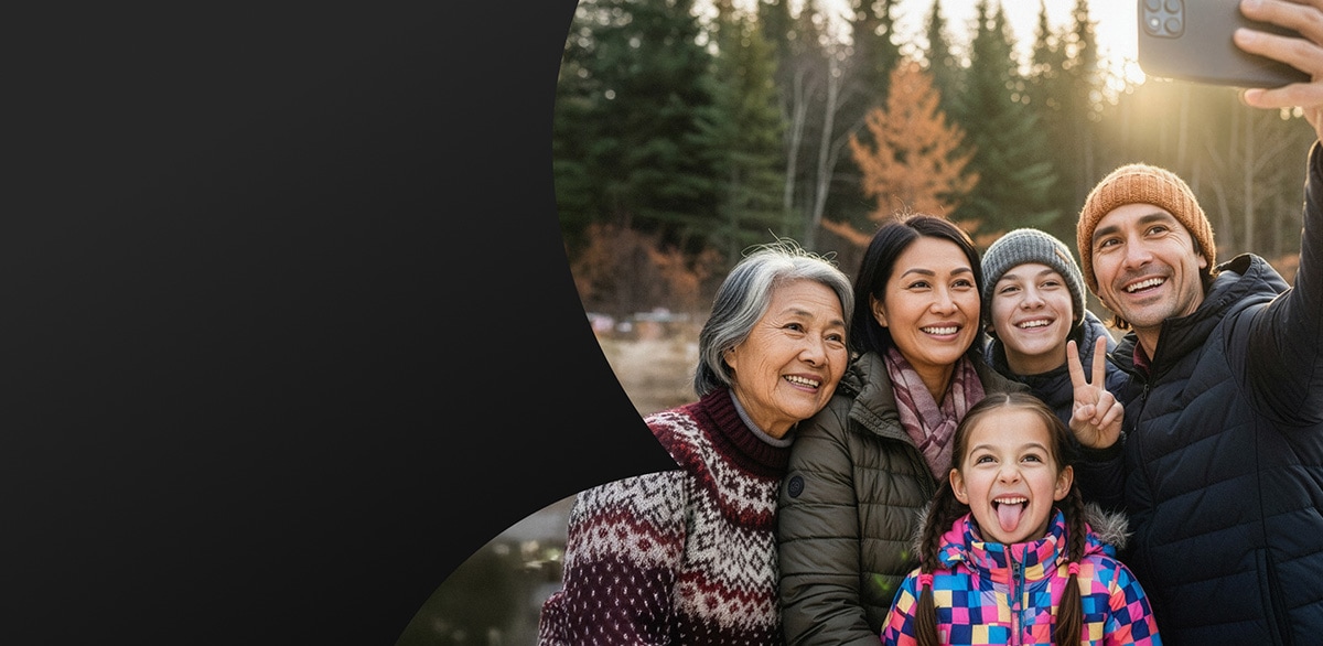 Two women smiling while looking at a smartphone, representing Bell Mobility offers.