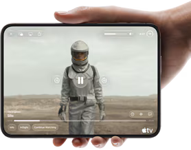 iPhone Duo, held with one hand, opened in horizontal orientation, fully unfolded, interior screen displays Apple TV show
